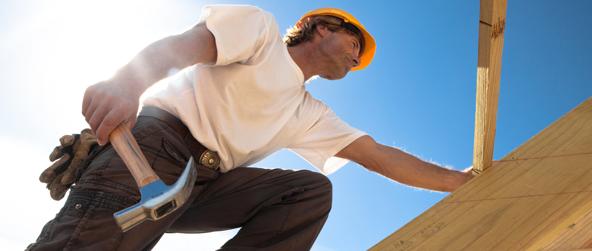 construction worker fixing a roof